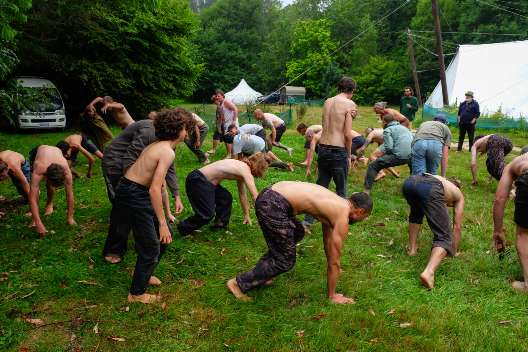 Fathers and sons moving together on the grass
